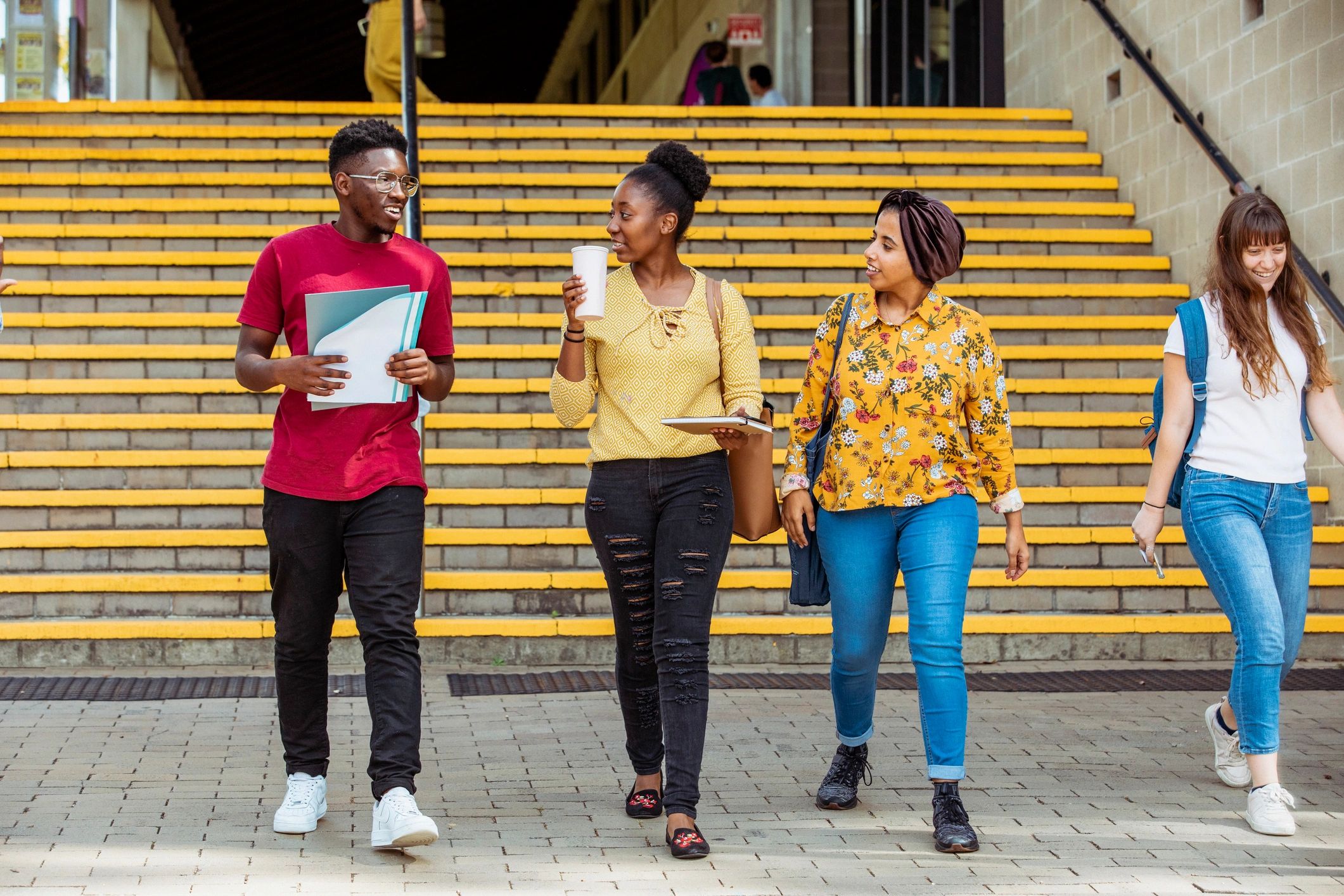 Diverse university students walking together on campus