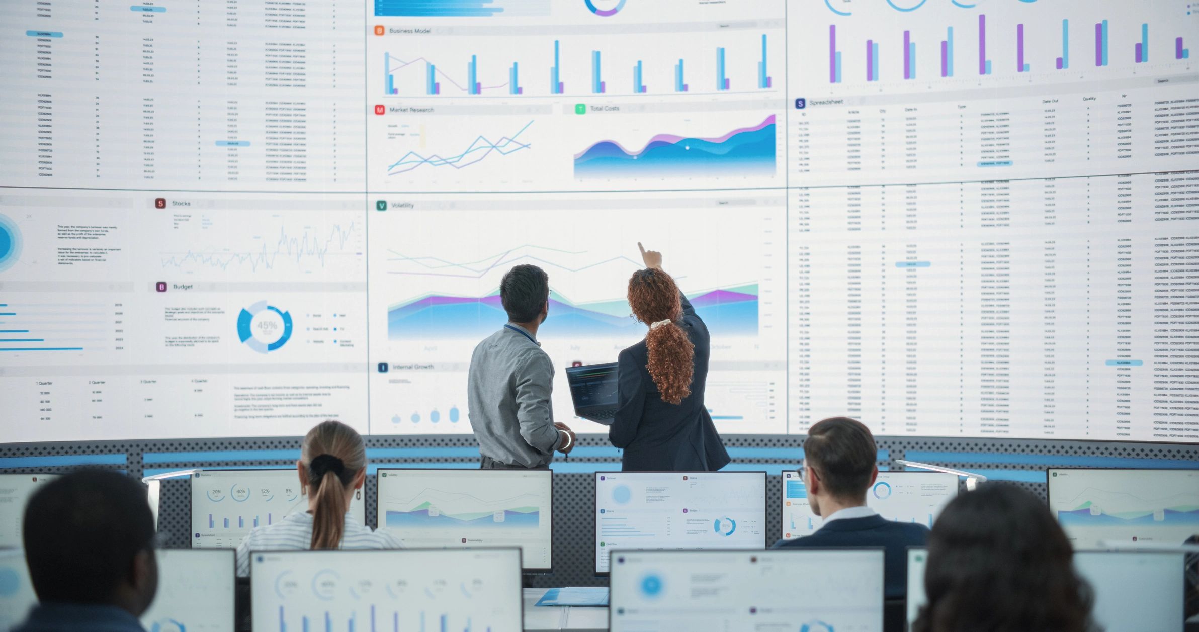 Business team analyzing performance data on a digital dashboard